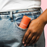 WooHoo Urban deodorant stick tucked into a jeans pocket