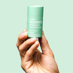 WooHoo Wild natural deodorant stick held in a hand