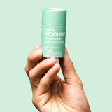 WooHoo Wild natural deodorant stick held in a hand