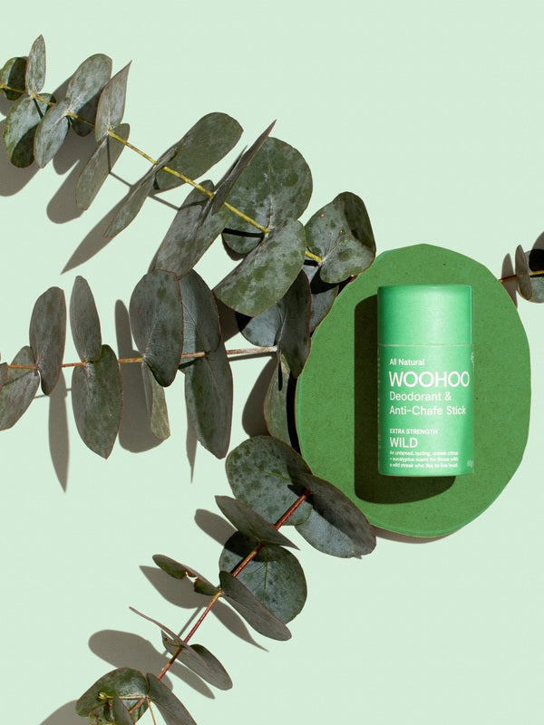 WooHoo Wild deodorant stick styled among eucalyptus branches