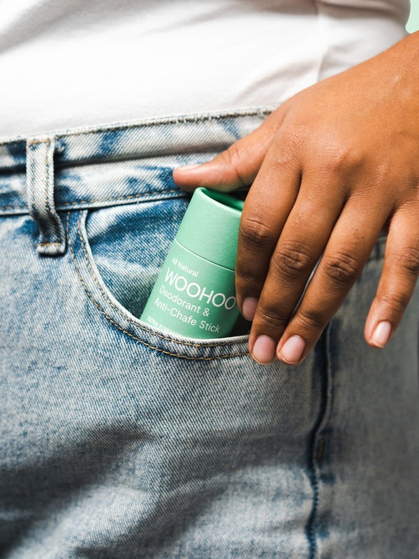 WooHoo Wild deodorant stick tucked into a jeans pocket