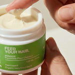 Finger scooping Yarok Feed Your Do Styling Pomade from the jar