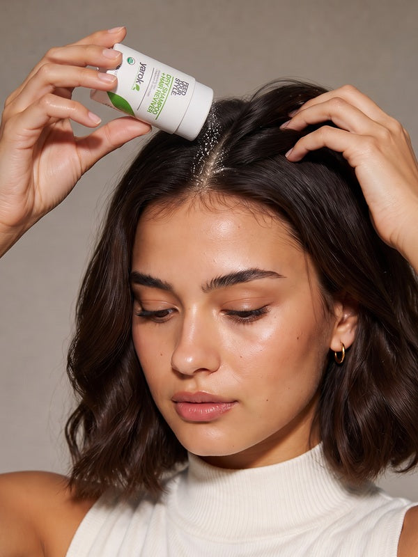 Woman applying Yarok Feed Your Style Dry Shampoo to her roots