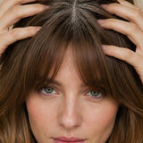 Woman massaging Yarok Feed Your Style Dry Shampoo into her scalp