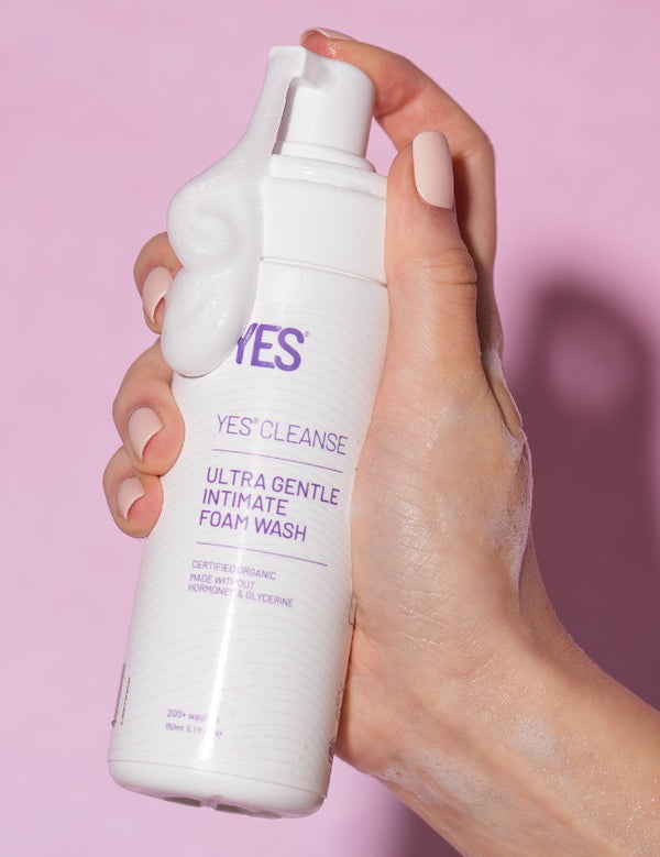Hand holding YES Cleanse Fragrance-Free Intimate Wash