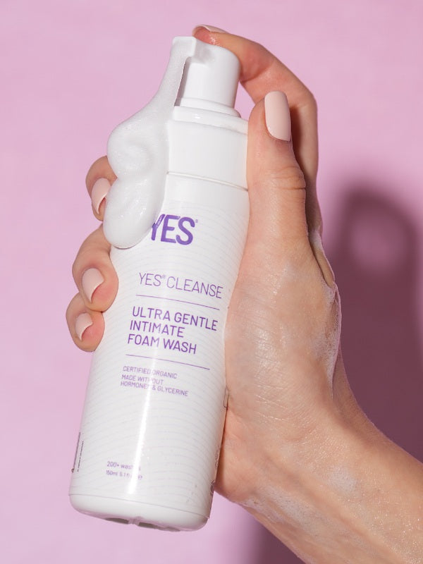 Hand holding YES Cleanse Fragrance-Free Intimate Wash