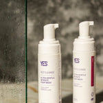 YES Cleanse Rose and Fragrance-Free Intimate Wash bottles in a shower