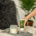 Hand picking up YES OB Plant Oil-Based Lubricant from a bedside tray