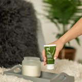 Hand picking up YES OB Plant Oil-Based Lubricant from a bedside tray