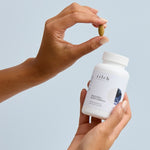 Hands holding Zilch Digestion + Bloat Formula and a tablet – Zilch Digestion + Bloat Formula 120 Tablets