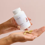 Hands holding Zilch PMS + Stress Formula and tablets – Zilch PMS + Stress Formula 120 Tablets