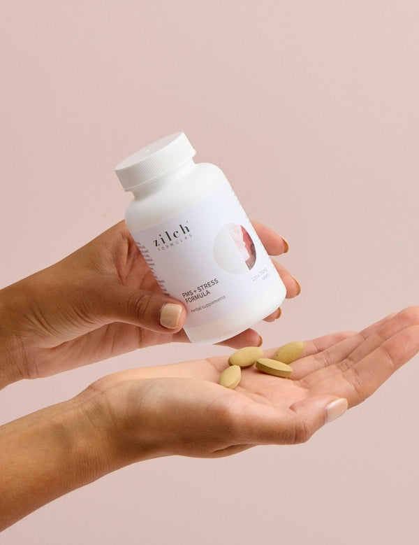 Hands holding Zilch PMS + Stress Formula and tablets – Zilch PMS + Stress Formula 120 Tablets