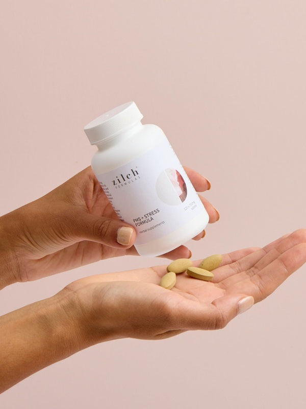 Hands holding Zilch PMS + Stress Formula and tablets – Zilch PMS + Stress Formula 120 Tablets